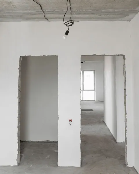 Unfinished room with bare floor and open doorways